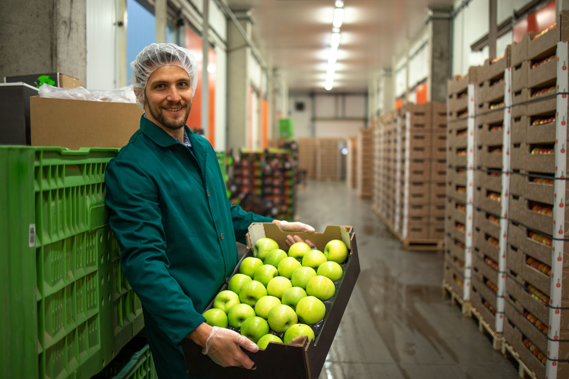 Man carrying a crate of apples